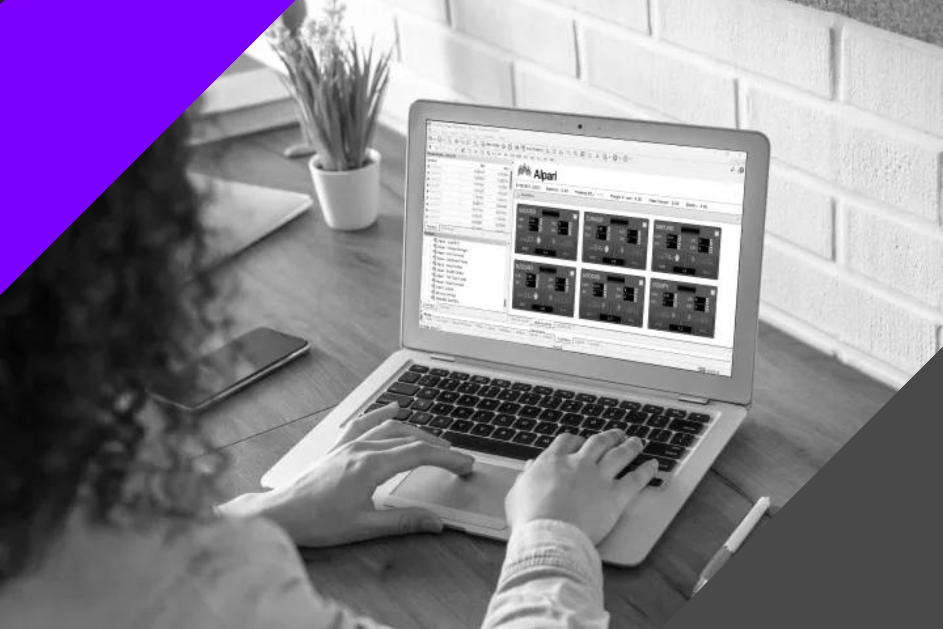 black and white photo of a woman using Alpari Pro Trading Tools on a laptop